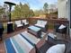 Well-furnished back deck featuring cushioned outdoor seating, a table, and a stylish rug at 1617 Heritage Club Ave, Wake Forest, NC 27587