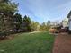 Large backyard featuring a brick patio with a fire pit and outdoor furniture at 1617 Heritage Club Ave, Wake Forest, NC 27587
