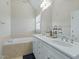 Bright bathroom featuring a double sink vanity, soaking tub, and neutral tile flooring at 1617 Heritage Club Ave, Wake Forest, NC 27587