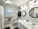 Bathroom featuring double vanity sinks, black framed mirrors, and walk-in shower at 1617 Heritage Club Ave, Wake Forest, NC 27587