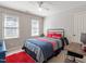 Bedroom featuring a ceiling fan, two windows, and modern decor at 1617 Heritage Club Ave, Wake Forest, NC 27587