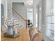 Warm dining area with hardwood floors, a wooden table, and a view of the staircase at 1617 Heritage Club Ave, Wake Forest, NC 27587