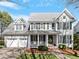 Beautiful two-story home with a covered front porch, two-car garage, and well-maintained landscaping at 1617 Heritage Club Ave, Wake Forest, NC 27587