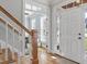 Welcoming foyer with hardwood floors, a staircase, and a clear view into another room at 1617 Heritage Club Ave, Wake Forest, NC 27587