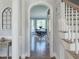 Elegant foyer with arched doorway leading to a dining area and a staircase with white railings at 1617 Heritage Club Ave, Wake Forest, NC 27587