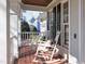 Charming front porch with rocking chairs, wooden floors, and classic white railings at 1617 Heritage Club Ave, Wake Forest, NC 27587