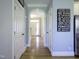 Bright hallway with hardwood floors, arched doorway, and white trim at 1617 Heritage Club Ave, Wake Forest, NC 27587