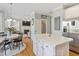 Kitchen and living room featuring hardwood floors, white cabinets, and stainless steel appliances at 1617 Heritage Club Ave, Wake Forest, NC 27587