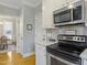 Kitchen features stainless steel appliances, wooden floors, and adjacent living area at 1617 Heritage Club Ave, Wake Forest, NC 27587