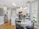Eat-in kitchen featuring white cabinets, stainless steel appliances, and wood floors at 1617 Heritage Club Ave, Wake Forest, NC 27587