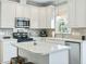 Modern kitchen featuring stainless steel appliances, island and tiled backsplash at 1617 Heritage Club Ave, Wake Forest, NC 27587