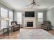 Bright living room boasts fireplace, recessed lighting, hardwood floors, and comfortable seating at 1617 Heritage Club Ave, Wake Forest, NC 27587
