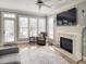 Inviting living room featuring a fireplace, large windows, hardwood floors, and neutral decor at 1617 Heritage Club Ave, Wake Forest, NC 27587