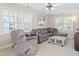 Cozy living room with neutral walls, plush sofa, and ample natural light at 1617 Heritage Club Ave, Wake Forest, NC 27587