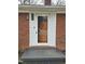 Traditional brick home showcasing the front door entrance with a welcome mat at 1713 Elder Ct, Burlington, NC 27215