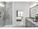 Bathroom featuring a glass shower and vanity, with an open doorway view to the bedroom at 1808 Angelonia Way, Fuquay Varina, NC 27526