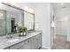 The modern bathroom features double sinks, ample counter space, and neutral tones, creating a clean and functional space at 1808 Angelonia Way, Fuquay Varina, NC 27526