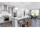 Bright kitchen features a large island with pendant lights and stainless steel appliances, creating a modern and inviting space at 1808 Angelonia Way, Fuquay Varina, NC 27526