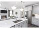 The kitchen offers a spacious island with a sink, stainless steel appliances, and modern finishes, perfect for cooking and entertaining at 1808 Angelonia Way, Fuquay Varina, NC 27526