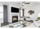 The inviting living room features a fireplace, large windows, and stylish decor, creating a warm and welcoming atmosphere at 1808 Angelonia Way, Fuquay Varina, NC 27526