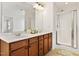 Bathroom featuring a double vanity, a large mirror, and a glass-enclosed shower at 2000 Muddy Creek Ct, Raleigh, NC 27610