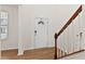 Bright entryway with wood floors, a staircase featuring wood and white railing, and a window with blinds at 2000 Muddy Creek Ct, Raleigh, NC 27610