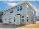 Two-story house featuring vinyl siding, double-pane windows, and a sliding glass door to the backyard at 2000 Muddy Ct, Raleigh, NC 27610