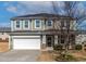 Charming two-story home boasts a two-car garage, welcoming front porch, and mature landscaping at 2000 Muddy Creek Ct, Raleigh, NC 27610
