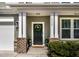 Elegant front entrance with a decorative wreath, potted plants, and a welcoming doormat at 2000 Muddy Creek Ct, Raleigh, NC 27610
