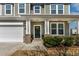 Charming front porch with decorative columns, brick accents, and a welcoming front door at 2000 Muddy Ct, Raleigh, NC 27610