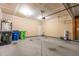 Spacious garage featuring a concrete floor, neutral-colored walls, and an automatic door opener at 2000 Muddy Creek Ct, Raleigh, NC 27610