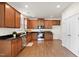 Bright kitchen features wood cabinets and granite counters with stainless steel appliances at 2000 Muddy Creek Ct, Raleigh, NC 27610
