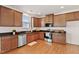 Well-lit kitchen features dark granite counters, wood cabinets, and stainless steel appliances at 2000 Muddy Creek Ct, Raleigh, NC 27610