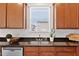 Kitchen window offers a view over the sink and the wood cabinets with granite counters are pristine at 2000 Muddy Creek Ct, Raleigh, NC 27610