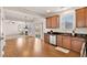 Open kitchen offers granite countertops and stainless steel dishwasher, seamlessly flowing into the living area at 2000 Muddy Creek Ct, Raleigh, NC 27610
