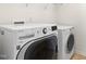 Bright laundry room featuring a front loading washer and dryer at 2000 Muddy Creek Ct, Raleigh, NC 27610