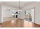 Open concept living room with hardwood floors and a sliding glass door to the backyard at 2000 Muddy Creek Ct, Raleigh, NC 27610