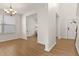 Bright living room with hardwood floors, chandelier, and large windows provides an open, airy space at 2000 Muddy Creek Ct, Raleigh, NC 27610