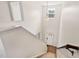 View from the top of a staircase looking down to the front door and entryway of a brightly lit home at 2000 Muddy Creek Ct, Raleigh, NC 27610