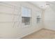 Walk-in closet with shelving, neutral carpet and walls, illuminated by two windows and ceiling light at 2000 Muddy Creek Ct, Raleigh, NC 27610