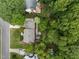 Aerial view of a home with a backyard deck, lush surrounding trees, and a well-maintained lawn at 2001 Carrington Dr, Raleigh, NC 27615