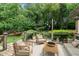Inviting back deck with comfortable seating, an outdoor rug, and views of lush greenery at 2001 Carrington Dr, Raleigh, NC 27615