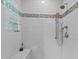 Modern bathroom with a shower, a marble bench and stylish gray and silver tile accents at 2001 Carrington Dr, Raleigh, NC 27615
