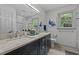 Bright bathroom featuring double sinks, a marble countertop, and modern fixtures at 2001 Carrington Dr, Raleigh, NC 27615