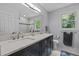 Bright bathroom featuring double vanity, modern fixtures, and a glass-enclosed shower at 2001 Carrington Dr, Raleigh, NC 27615