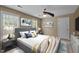 Cozy bedroom with a comfortable bed, stylish decor, and two windows providing natural light at 2001 Carrington Dr, Raleigh, NC 27615