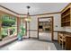 Bright dining room featuring large window, pendant light, and open view to adjacent living space at 2001 Carrington Dr, Raleigh, NC 27615
