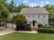 Charming two-story home featuring a manicured lawn, mature trees, and a welcoming entrance at 2001 Carrington Dr, Raleigh, NC 27615