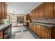 Spacious kitchen with wood cabinets and tile countertops leading to a dining area and living space at 2001 Carrington Dr, Raleigh, NC 27615