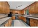Traditional style kitchen featuring wood cabinets, black appliances, and contrasting countertops at 2001 Carrington Dr, Raleigh, NC 27615
